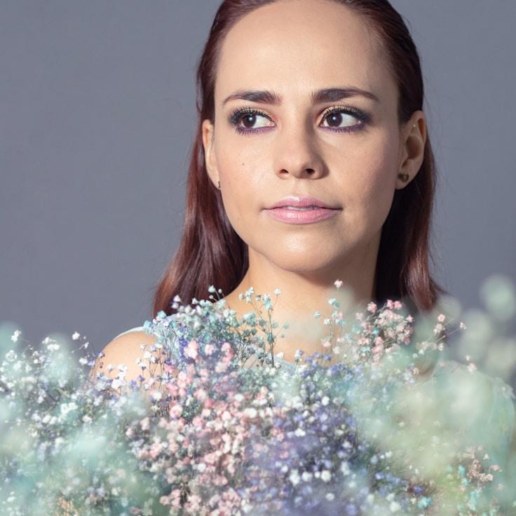 Aisha Patel, Lead Design Curator at Frosted Peak Solutions, reviewing corporate floral arrangements